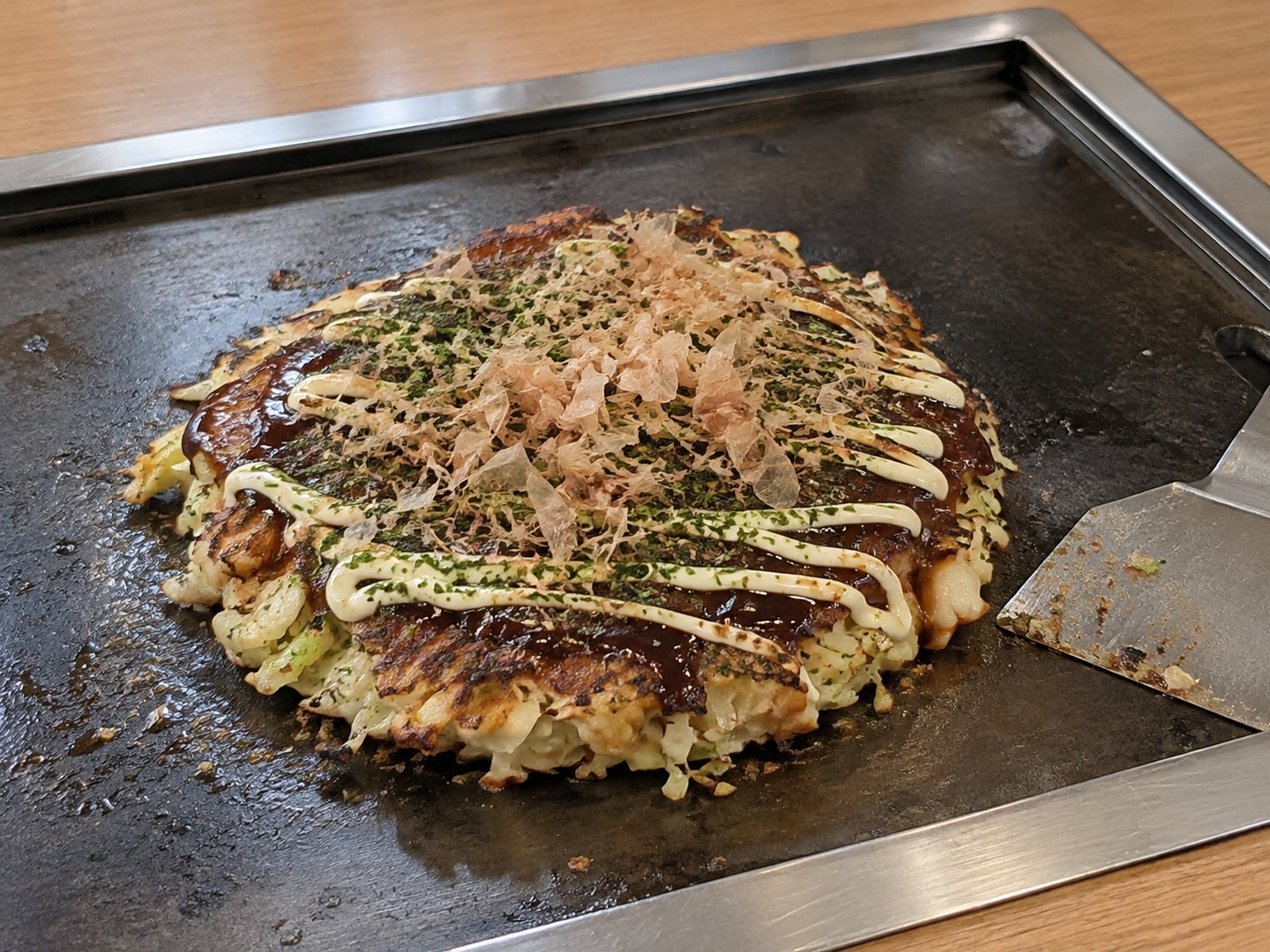 Illustration of Okonomiyaki; ordinary seasoned flat steel restaurant teppan