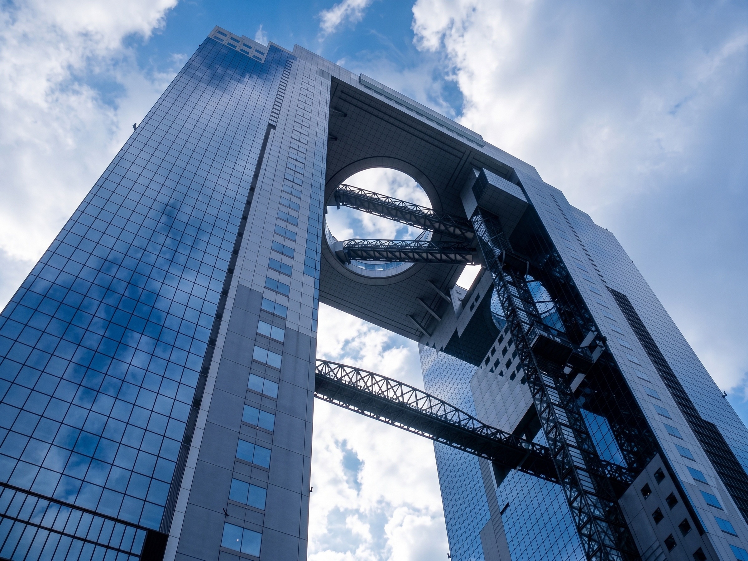 Looking up at the connected towers and circular opening of Umeda Sky Building